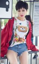 A woman wearing a t-shirt with a teddy bear on it.