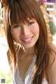 A woman with long brown hair smiling at the camera.